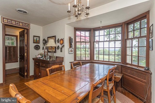 dining room featuring a notable chandelier and dark hardwood / wood-style floors