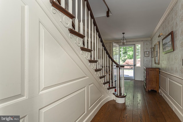 foyer featuring ornamental molding and dark hardwood / wood-style flooring