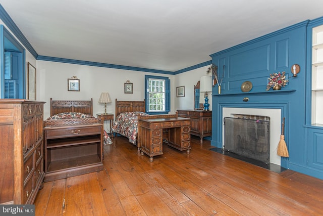 bedroom featuring ornamental molding and hardwood / wood-style flooring