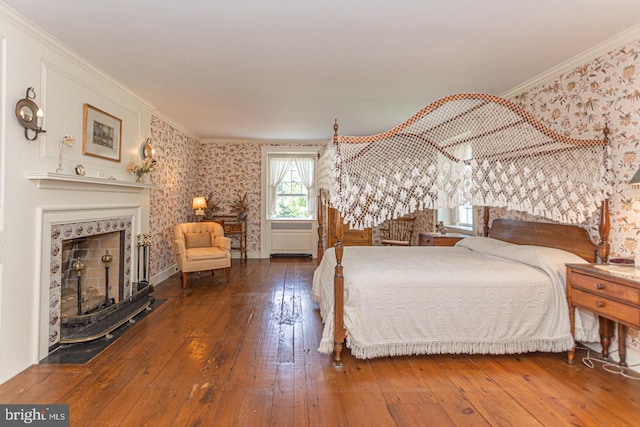 bedroom featuring ornamental molding and hardwood / wood-style flooring