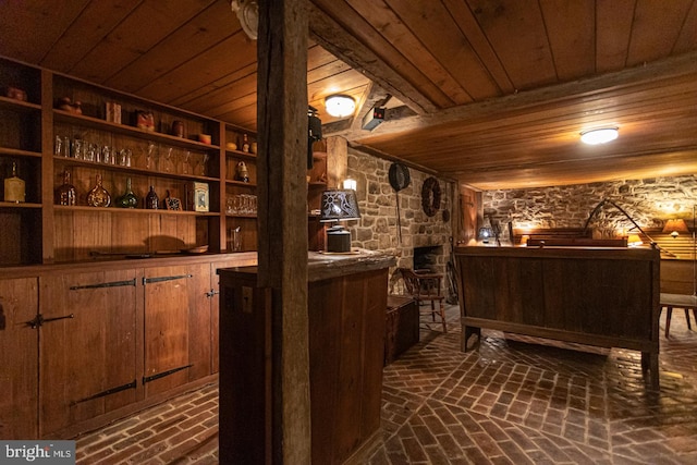 wine room with wooden ceiling and indoor bar