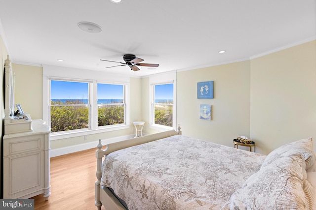 bedroom with ceiling fan, ornamental molding, and light hardwood / wood-style floors