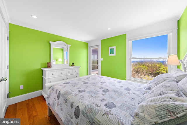 bedroom with crown molding and wood-type flooring