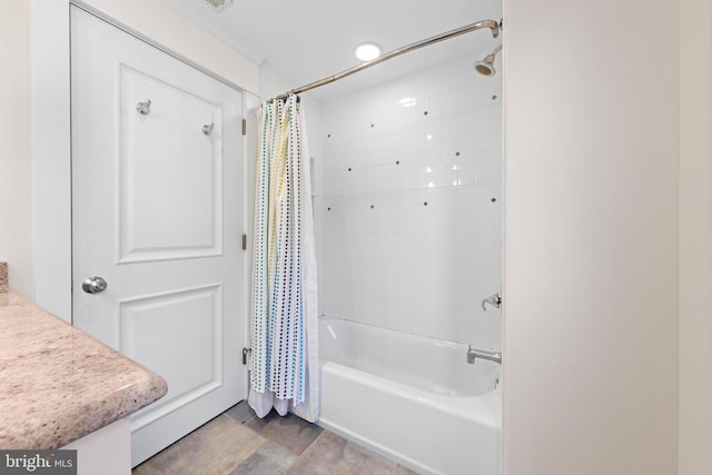 bathroom with ornamental molding and shower / tub combo