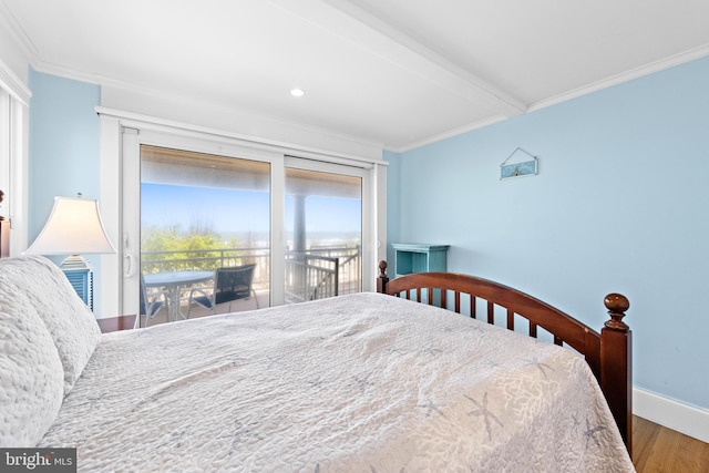 bedroom with crown molding, hardwood / wood-style floors, and access to outside