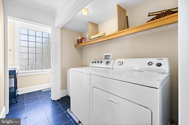 clothes washing area with washer and dryer, ornamental molding, hookup for a washing machine, and dark tile floors