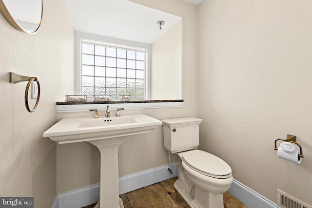 bathroom with tile floors and toilet