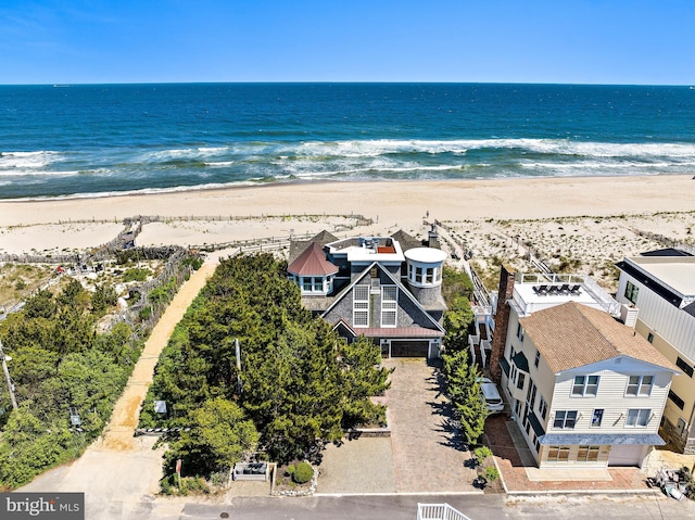 birds eye view of property with a view of the beach and a water view