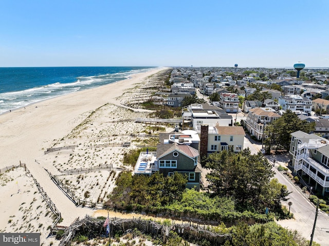 drone / aerial view with a beach view and a water view