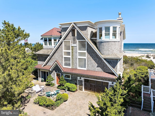 view of front of house with a water view and a garage