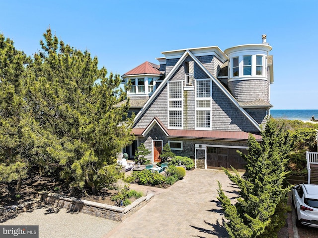 view of front of home featuring a garage and a water view