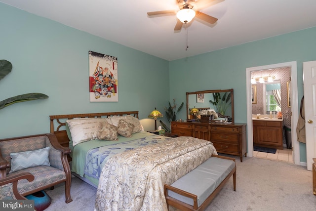 carpeted bedroom featuring connected bathroom and ceiling fan