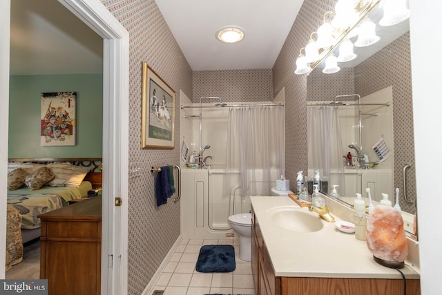 bathroom with toilet, a shower with curtain, vanity, and tile patterned floors