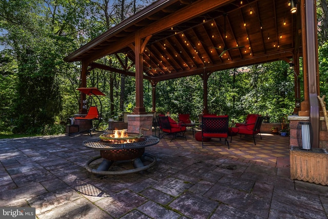 view of patio featuring a gazebo and a fire pit