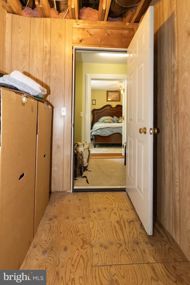 corridor featuring wood walls