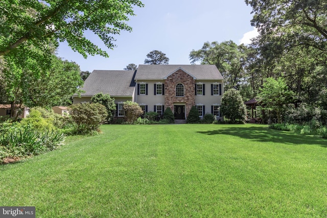 colonial inspired home with a front yard