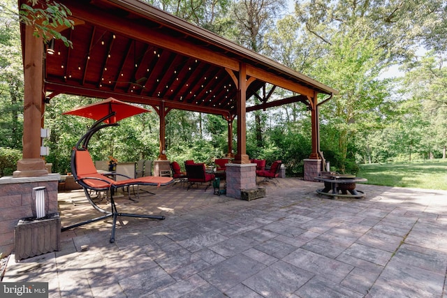 view of patio / terrace featuring a gazebo and an outdoor fire pit