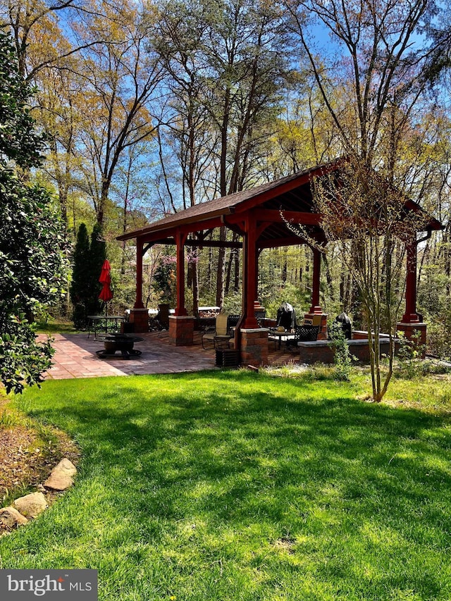 view of home's community with a gazebo, a patio, and a lawn