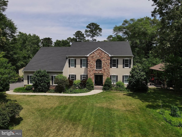 colonial-style house with a front lawn