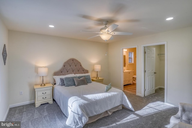 bedroom featuring a closet, connected bathroom, a spacious closet, carpet flooring, and ceiling fan