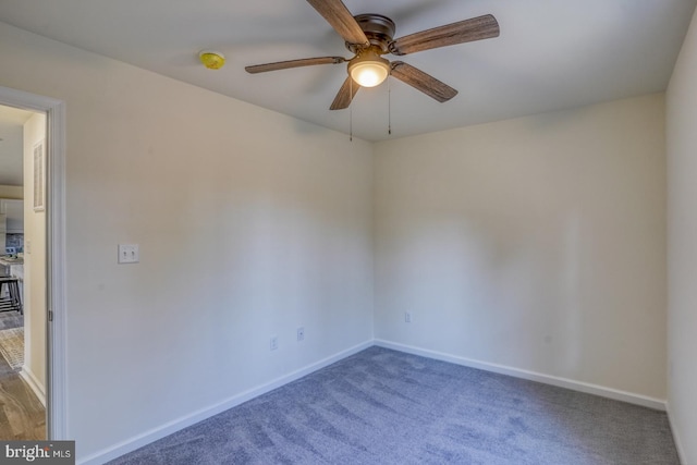 unfurnished room featuring ceiling fan and carpet floors