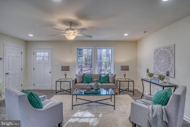 living room with ceiling fan, plenty of natural light, and hardwood / wood-style flooring