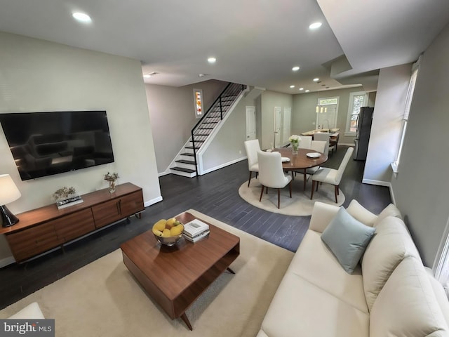 living room with dark hardwood / wood-style flooring and sink