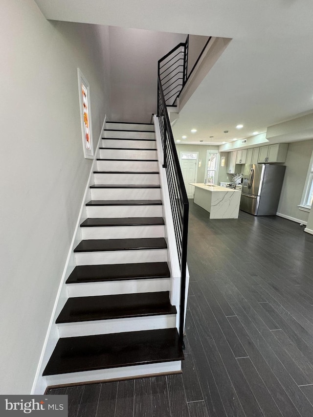 staircase featuring wood-type flooring