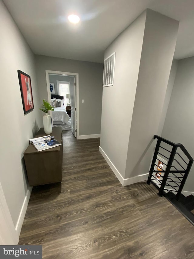 hallway with dark hardwood / wood-style flooring