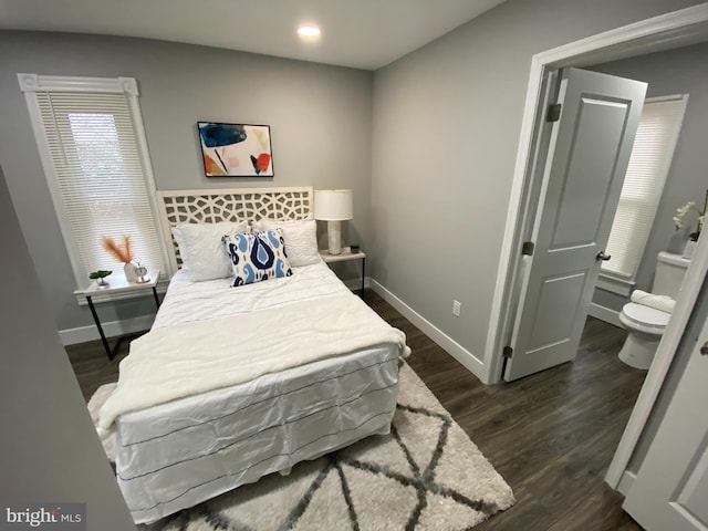 bedroom with dark hardwood / wood-style floors