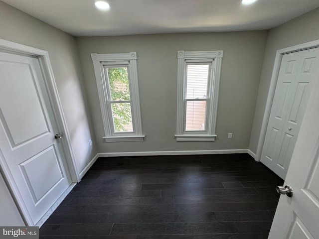 unfurnished bedroom with dark wood-type flooring