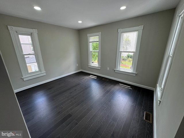 spare room featuring dark wood-type flooring