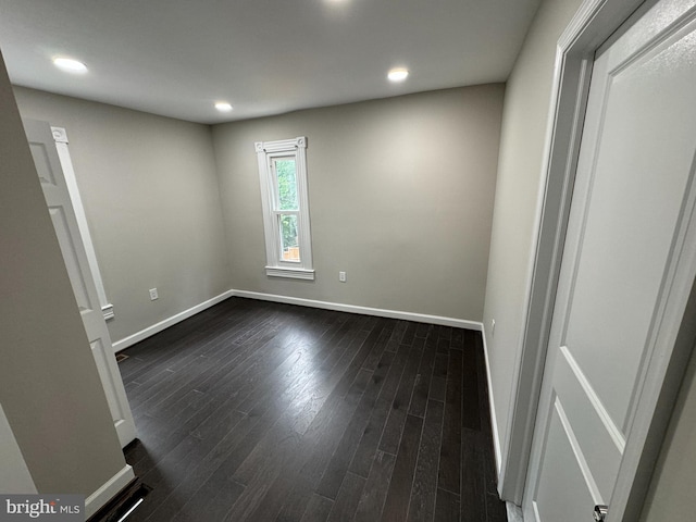 unfurnished room with dark hardwood / wood-style floors