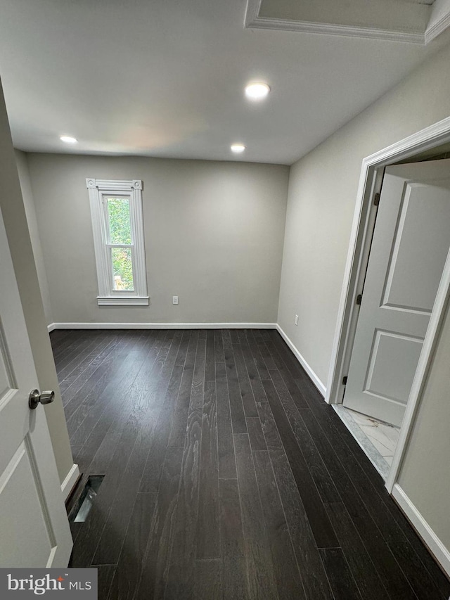 empty room with dark hardwood / wood-style flooring