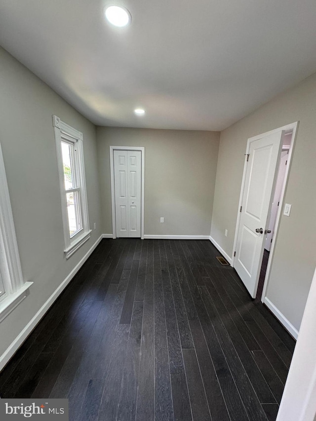 spare room featuring dark wood-type flooring