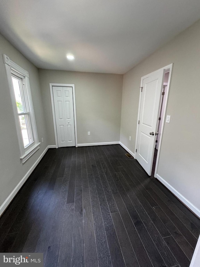 spare room with dark hardwood / wood-style flooring