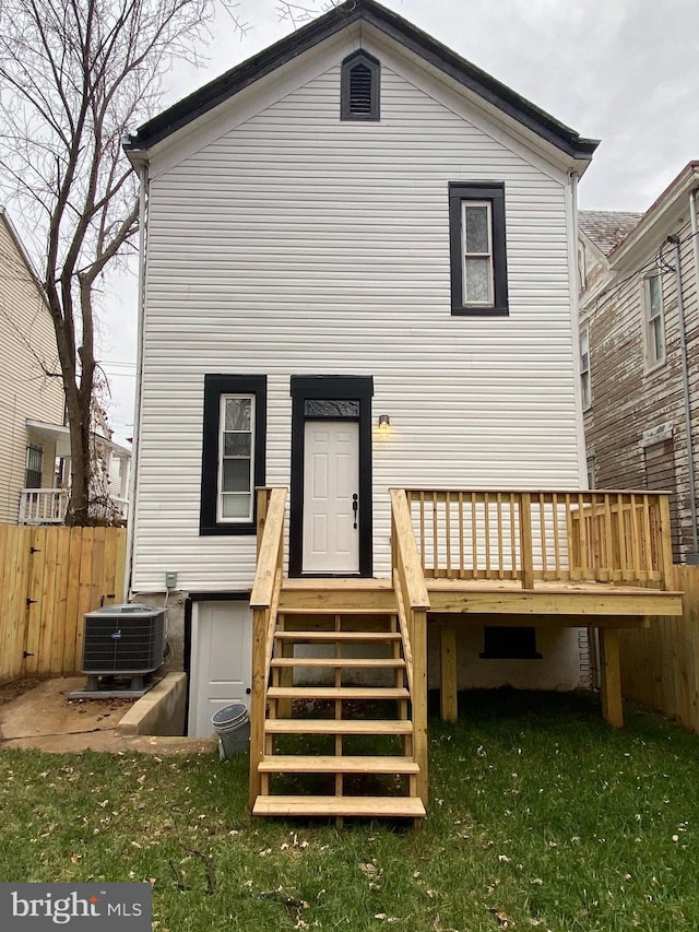 back of house featuring central AC, a yard, and a deck