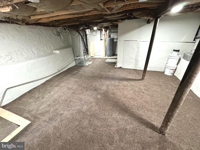 basement featuring heating unit and water heater