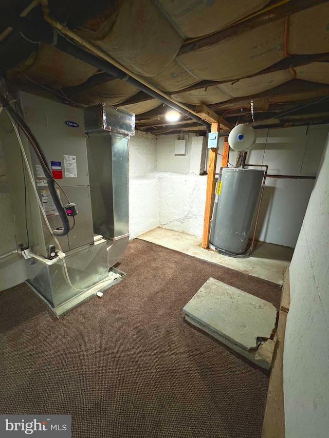 basement with carpet flooring, heating unit, and gas water heater