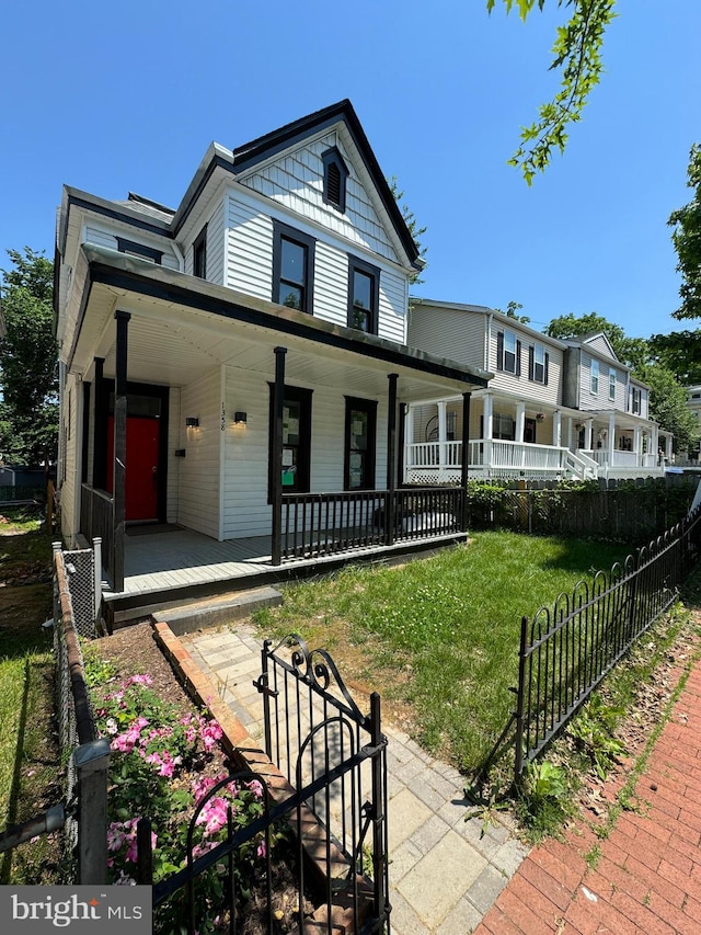 view of front of home featuring a front yard and a porch