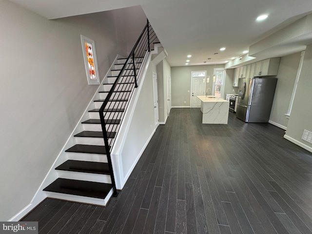 stairway featuring sink and hardwood / wood-style flooring