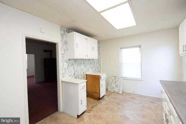 kitchen featuring decorative backsplash and white cabinetry