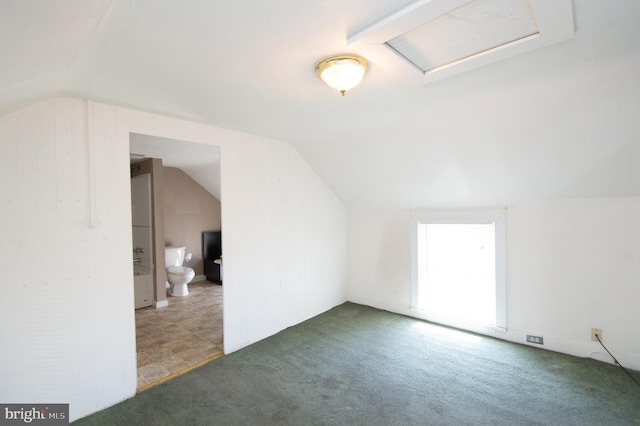 additional living space with carpet flooring and vaulted ceiling