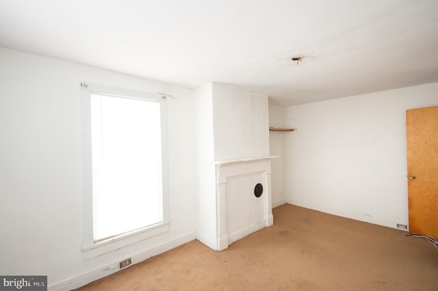 clothes washing area featuring light colored carpet