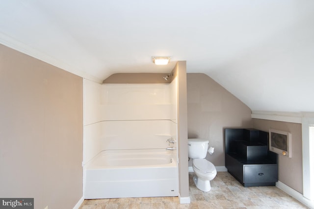 bathroom featuring  shower combination, toilet, and lofted ceiling