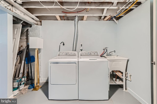 washroom with electric dryer hookup, washer and dryer, and hookup for a washing machine