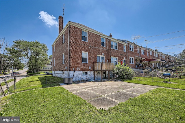 exterior space featuring a lawn and central AC unit