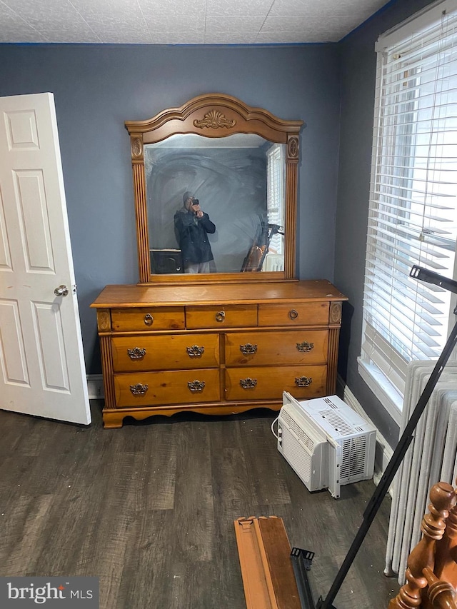 bedroom featuring dark hardwood / wood-style floors and radiator