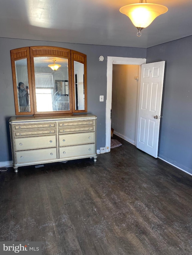 unfurnished bedroom featuring dark hardwood / wood-style floors