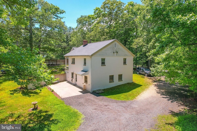 view of side of property featuring a yard and a garage